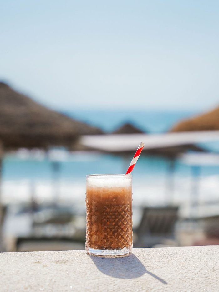 An iced coffee by the parasols.