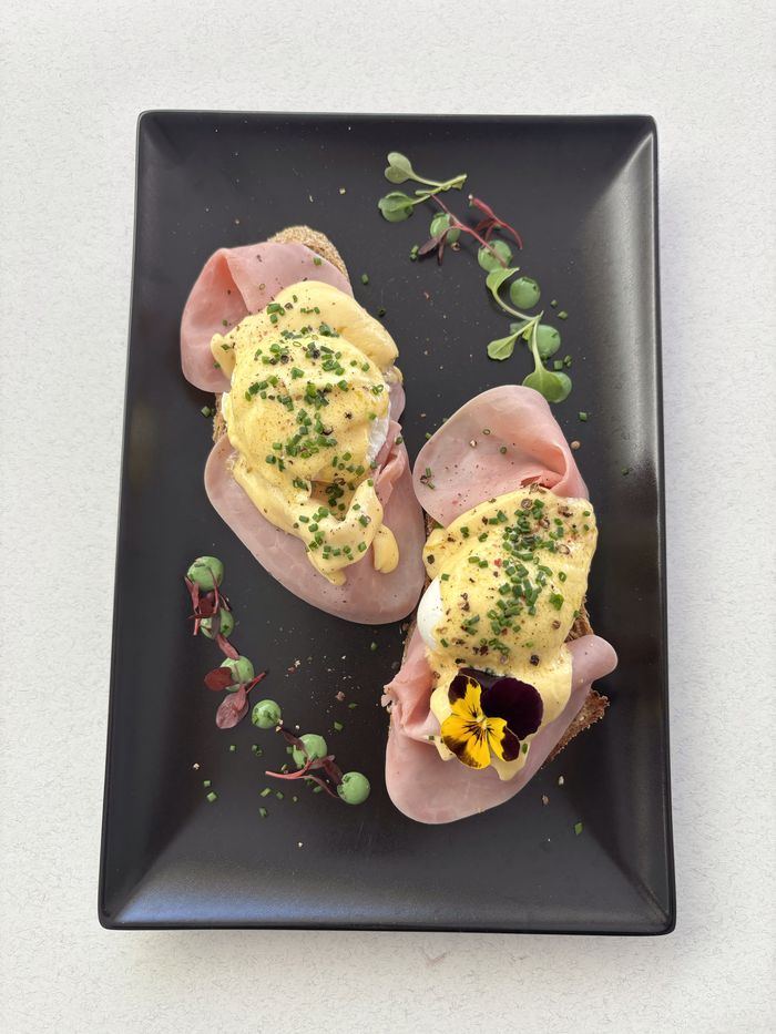Eggciting Benedict: ham, poached eggs, chives and hollandaise.