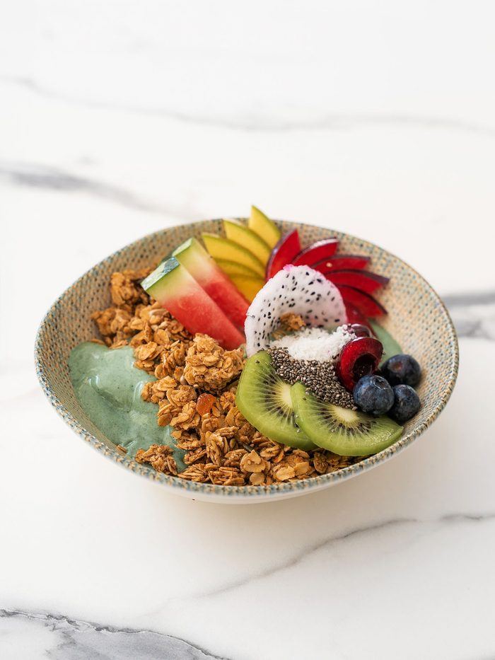 A granola bowl with fruit and yoghurt.