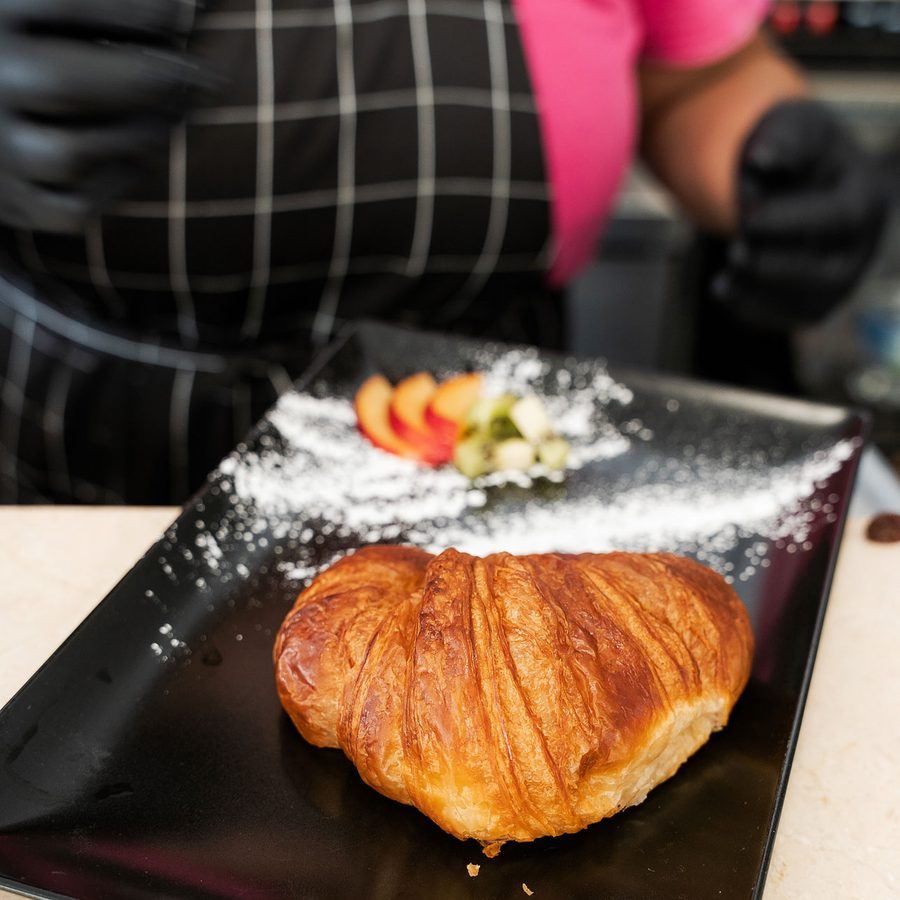 A croissant on a slate plate.