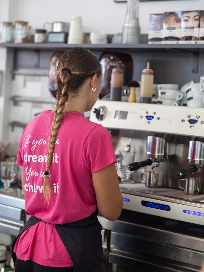 A barista at the espresso machine.