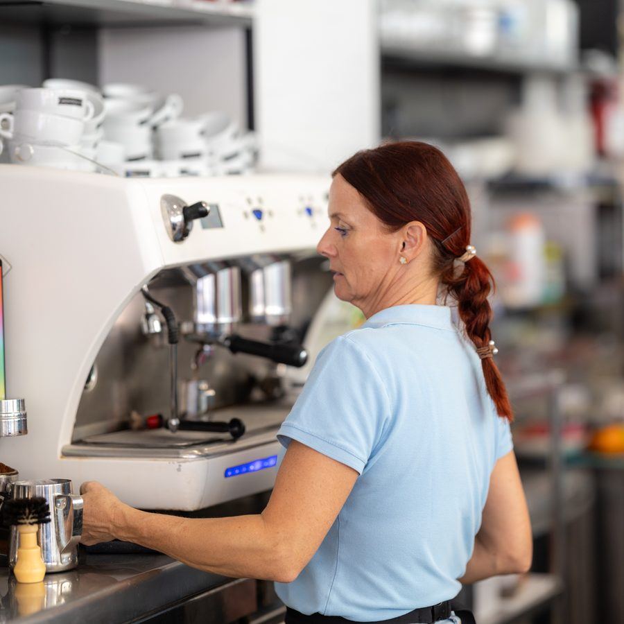 A barista at Café Nomad tamping a shot of organic espresso.